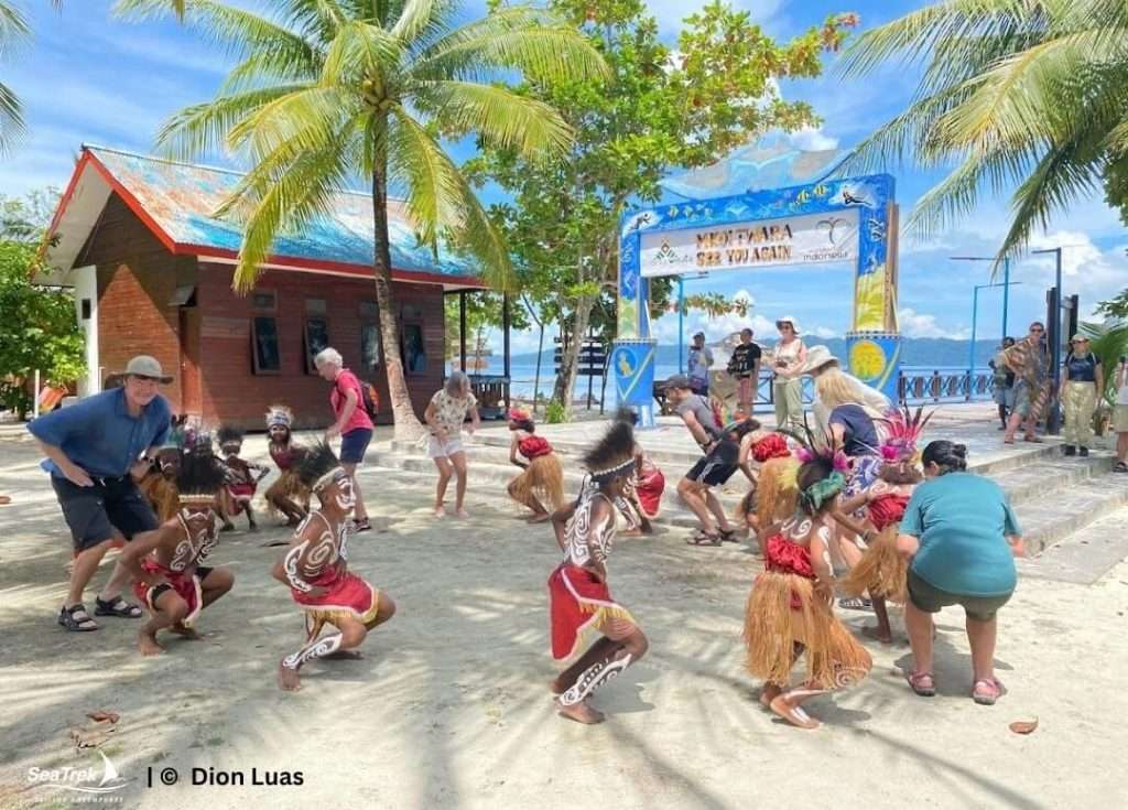 guests participate in the traditional dance with locals in raja ampat
